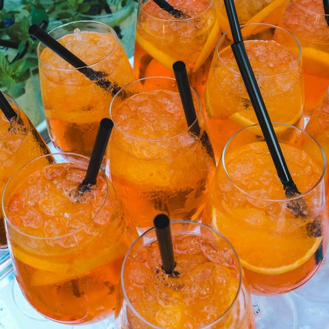 Inn & Restaurant in Parsberg serving regional cuisine Several glasses of orange drink with black straws on a tray