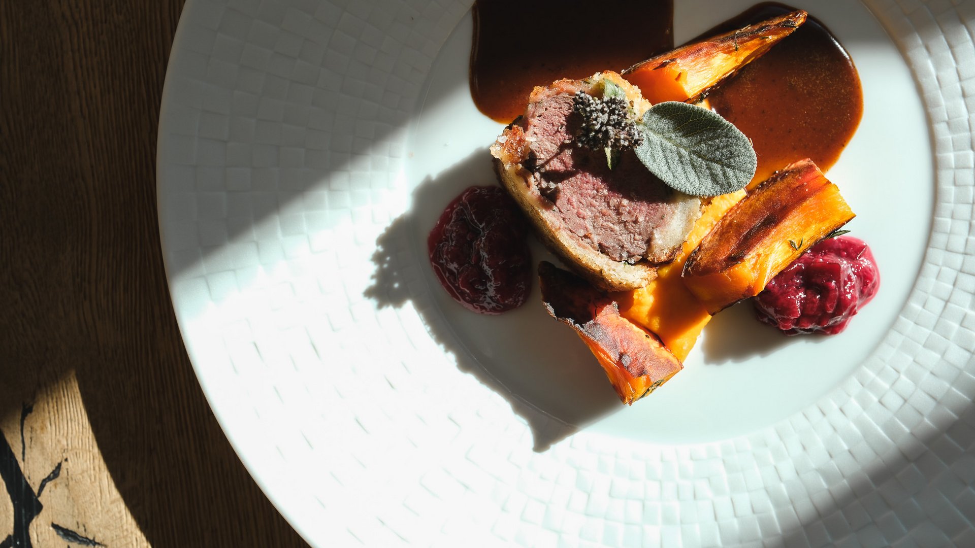 Fine Dining & Gourmet Cuisine in the Upper Palatinate Plated dish with meat, orange vegetables, dark sauce and a leaf garnish