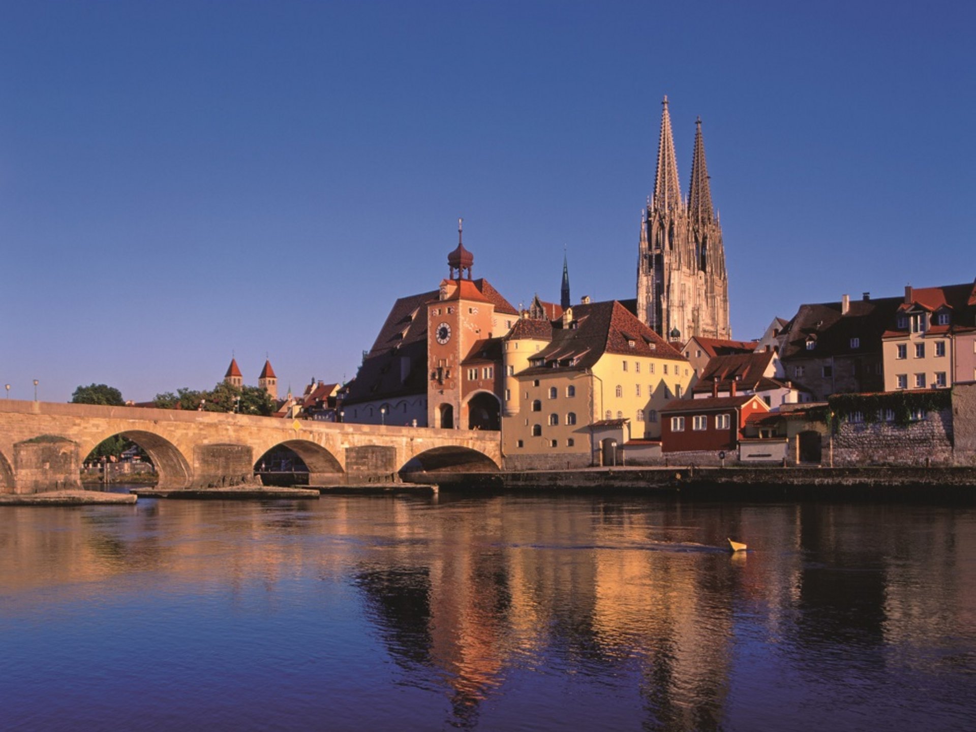 Culture & Attractions Around Regensburg View of Regensburg with stone bridge and cathedral at sunset