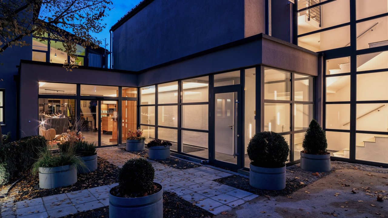 Looking back Modern building with glass facade and illuminated stairway at night