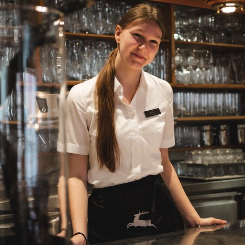 Gasthof & Restaurant in Parsberg mit regionaler Küche Lächelnde Kellnerin hinter der Bar mit Gläsern im Hintergrund
