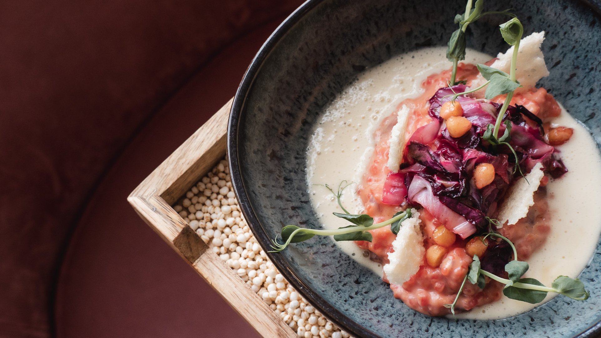 Restaurant in Parsberg: Enjoy gourmet Creative dish with red ingredients and green herbs in a black bowl