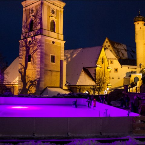 Hotels in Regensburg and its surroundings: culturally rich! Ice rink with purple lighting in front of historic buildings at night