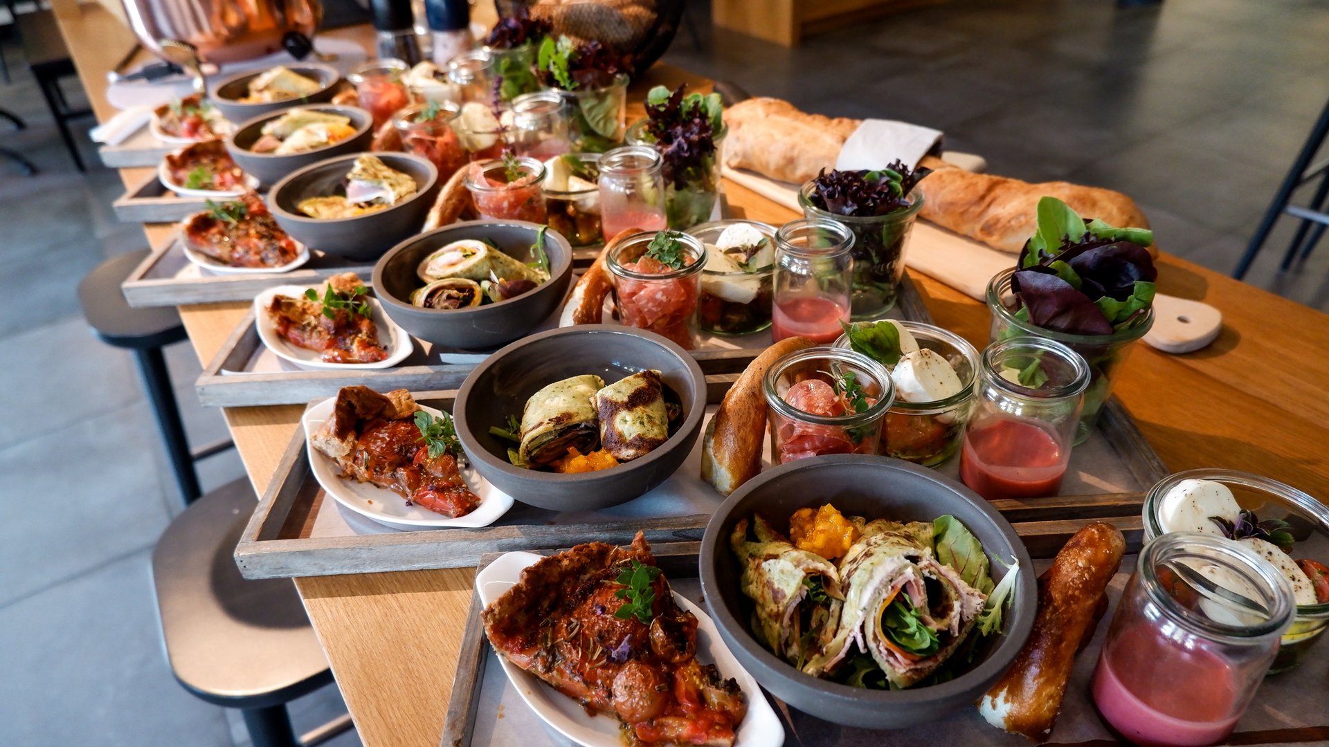 Services and rates for conferences and celebrations Various antipasti and snacks on trays on a wooden table