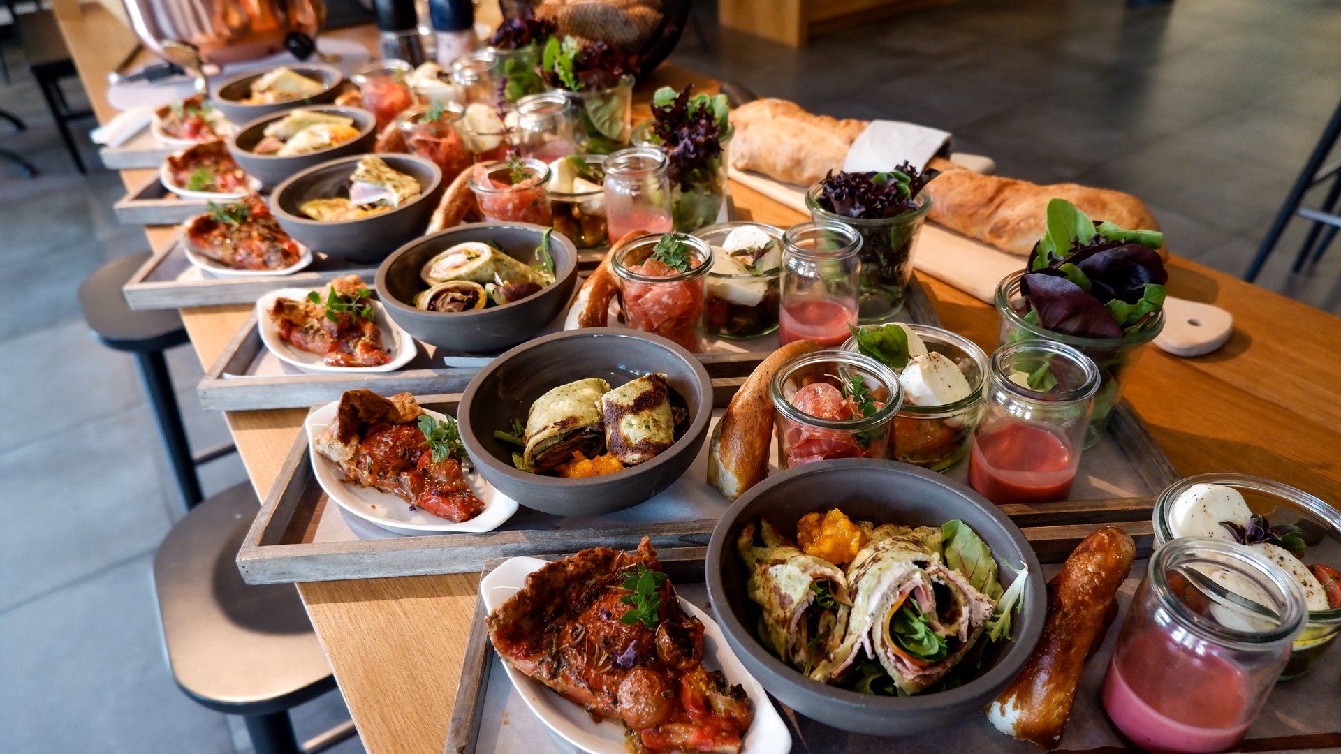 Services and rates for conferences and celebrations Various antipasti and snacks on trays on a wooden table